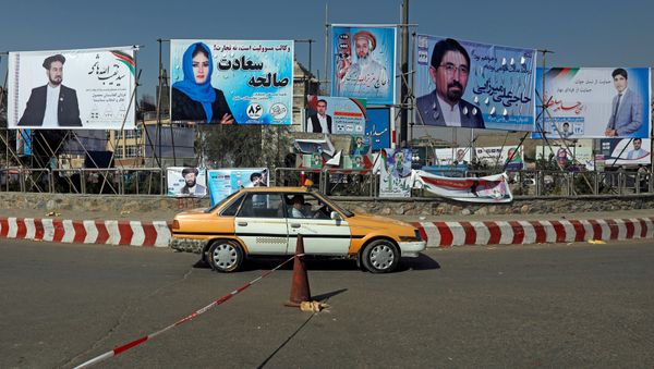 A vehicle drives in front of election posters of parliamentarian candidates installed during the first day of elections campaign in Kabul, Afghanistan September 28, 2018 A vehicle drives in front of election posters of parliamentarian candidates installed during the first day of elections campaign in Kabul, Afghanistan September 28, 2018 - Sputnik International