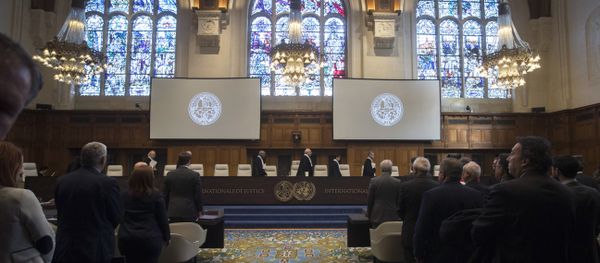 The delegations of the U.S., front left, and the Islamic Republic of Iran, front right, rise as judges, rear, enter the International Court of Justice, or World Court, in The Hague, Netherlands, Wednesday, Oct. 3, 2018, to rule on an Iranian request to order Washington to suspend sanctions against Tehran The delegations of the U.S., front left, and the Islamic Republic of Iran, front right, rise as judges, rear, enter the International Court of Justice, or World Court, in The Hague, Netherlands, Wednesday, Oct. 3, 2018, to rule on an Iranian request to order Washington to suspend sanctions against Tehran - Sputnik International
