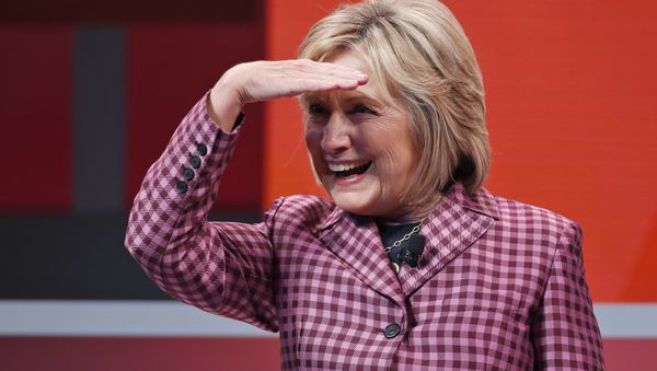 Former Secretary of State Hillary Clinton shields her eyes as she takes her seat to talk with Jeffrey Goldberg, editor in chief of The Atlantic, during The Atlantic Festival, Tuesday, Oct. 2, 2018, in Washington. - Sputnik International