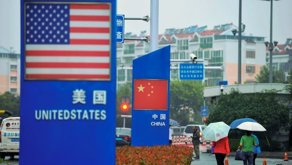 Signs with the US flag and Chinese flag are seen outside a store selling foreign goods in Qingdao in China's eastern Shandong province on September 19, 2018 Signs with the US flag and Chinese flag are seen outside a store selling foreign goods in Qingdao in China's eastern Shandong province on September 19, 2018 - Sputnik International
