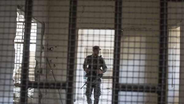 A member of the U.S.-backed Syrian Democratic Forces (SDF) walk inside a prison built by Islamic State fighters at the stadium that was the site of IS fighters' last stand in the city of Raqqa, Syria, Friday, Oct. 20, 2017 A member of the U.S.-backed Syrian Democratic Forces (SDF) walk inside a prison built by Islamic State fighters at the stadium that was the site of IS fighters' last stand in the city of Raqqa, Syria, Friday, Oct. 20, 2017 - Sputnik International