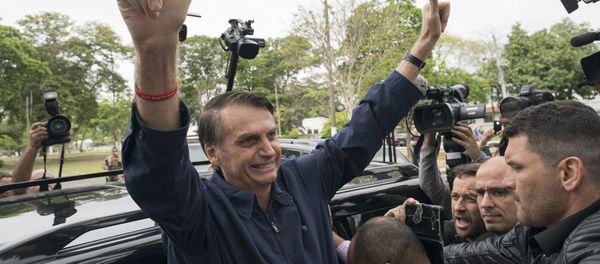 Presidential frontrunner Jair Bolsonaro, of the Social Liberal Party, flashes thumbs up to supporters after voting at a polling station in Rio de Janeiro, Brazil, Sunday, Oct. 7, 2018. Presidential frontrunner Jair Bolsonaro, of the Social Liberal Party, flashes thumbs up to supporters after voting at a polling station in Rio de Janeiro, Brazil, Sunday, Oct. 7, 2018. - Sputnik International