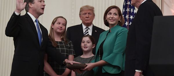 President Donald Trump, center, listens as retired Supreme Court Justice Anthony Kennedy, right, ceremonially swears-in Supreme Court Justice Brett Kavanaugh, left, in the East Room of the White House in Washington, Monday, Oct. 8, 2018. Kavanaugh's wife Ashley watches, second from right with daughters Margaret, left, and Liza. - Sputnik International