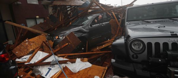 A storm chaser climbs into his vehicle during the eye of Hurricane Michael to retrieve equipment after a hotel canopy collapsed in Panama City Beach, Fla., Wednesday, Oct. 10, 2018 A storm chaser climbs into his vehicle during the eye of Hurricane Michael to retrieve equipment after a hotel canopy collapsed in Panama City Beach, Fla., Wednesday, Oct. 10, 2018 - Sputnik International