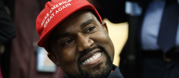 Rapper Kanye West smiles as he listens to a question from a reporter during a meeting in the Oval Office of the White House with President Donald Trump, Thursday, Oct. 11, 2018, in Washington. - Sputnik International