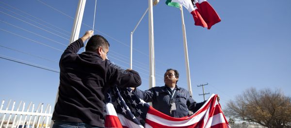In this Friday, Dec. 27, 2013 photo, workers at one of maquiladoras of the TECMA group prepare to raise the U.S. flag along with the Mexican and TECMA flags in Ciudad Juarez, Mexico - Sputnik International
