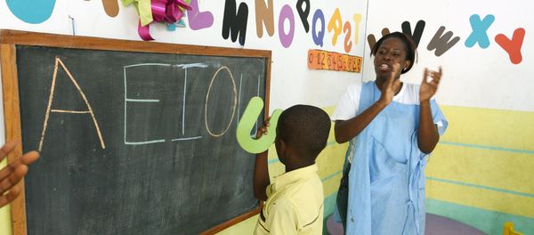 A teacher applauds an autistic child in classroom in Abidjan, Ivory Coast. Autism is less likely to be diagnosed in the developing world - Sputnik International