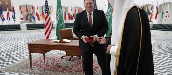 US Secretary of State Mike Pompeo receives a gift during a visit to the Saudi capital Riyadh, on October 16, 2018. Pompeo held talks with Saudi King Salman seeking answers about the disappearance of journalist Jamal Khashoggi, amid US media reports the kingdom may be mulling an admission he died during a botched interrogation. US Secretary of State Mike Pompeo receives a gift during a visit to the Saudi capital Riyadh, on October 16, 2018. Pompeo held talks with Saudi King Salman seeking answers about the disappearance of journalist Jamal Khashoggi, amid US media reports the kingdom may be mulling an admission he died during a botched interrogation. - Sputnik International