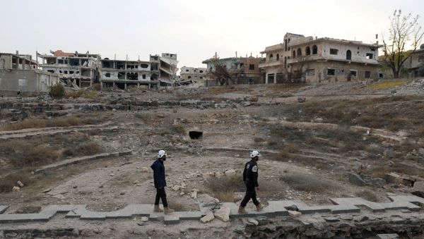 Members of the Civil Defence, also known as the 'White Helmets', are seen inspecting the damage at a Roman ruin site in Daraa, Syria (File) Members of the Civil Defence, also known as the 'White Helmets', are seen inspecting the damage at a Roman ruin site in Daraa, Syria (File) - Sputnik International