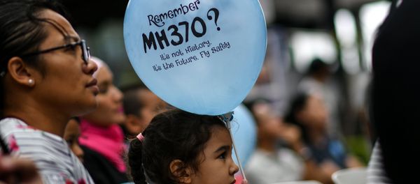 A young girl holds a balloon with a message during a memorial event for the missing Malaysia Airlines flight MH370, in Kuala Lumpur on March 3, 2018 ahead of the fourth anniversary of the ill-fated plane’s disappearance A young girl holds a balloon with a message during a memorial event for the missing Malaysia Airlines flight MH370, in Kuala Lumpur on March 3, 2018 ahead of the fourth anniversary of the ill-fated plane’s disappearance - Sputnik International