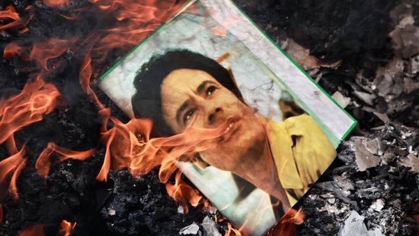 A portrait of Muammar Gaddafi burning in a fire. A portrait of Muammar Gaddafi burning in a fire. - Sputnik International