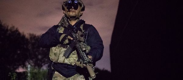An agent with the U.S. Border Patrol Tactical Unit guards the U.S. side of the border wall with Mexico in Brownsville, Texas, U.S. An agent with the U.S. Border Patrol Tactical Unit guards the U.S. side of the border wall with Mexico in Brownsville, Texas, U.S. - Sputnik International
