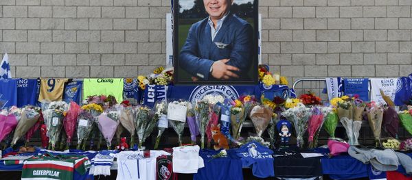 A portrait of Leicester City Football Club's Thai chairman Vichai Srivaddhanaprabha, who died in a helicopter crash at the club's stadium, is seen amid flowers and tributes outside the King Power Stadium in Leicester, eastern England, on October 29, 2018 A portrait of Leicester City Football Club's Thai chairman Vichai Srivaddhanaprabha, who died in a helicopter crash at the club's stadium, is seen amid flowers and tributes outside the King Power Stadium in Leicester, eastern England, on October 29, 2018 - Sputnik International