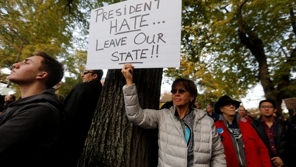 A participant in the march in memory of the victims of the Tree of Life Synagogue shooting, holds a sign opposing U.S. President Donald Trump, in Pittsburgh, Pennsylvania, U.S., October 30, 2018. A participant in the march in memory of the victims of the Tree of Life Synagogue shooting, holds a sign opposing U.S. President Donald Trump, in Pittsburgh, Pennsylvania, U.S., October 30, 2018. - Sputnik International