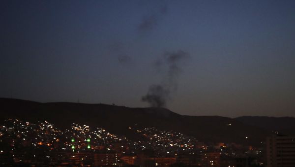 Smoke rises after airstrikes targeting different parts of the Syrian capital Damascus, Syria - Sputnik International