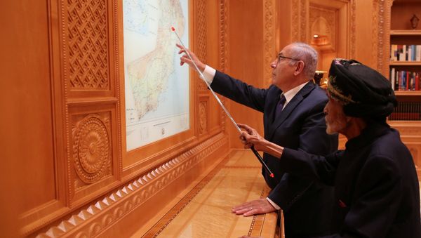 Israeli Prime Minister Benjamin Netanyahu looks at maps with Sultan Qaboos bin Said in this undated handout provided by the Israel Prime Minister Office, in Oman - Sputnik International