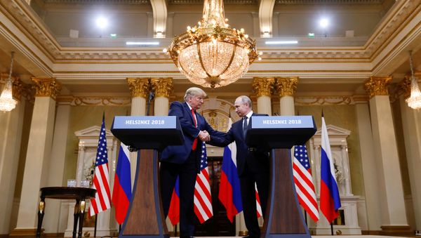 U.S. President Donald Trump and Russia's President Vladimir Putin shake hands during a joint news conference after their meeting in Helsinki, Finland, July 16, 2018 - Sputnik International