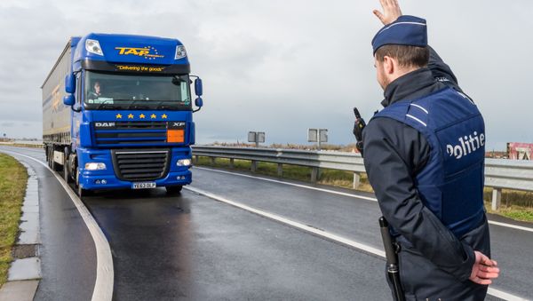 A police man stops a truck on the French-Belgian border in Adinkerke, Belgium, on Wednesday, Feb. 24, 2016. - Sputnik International