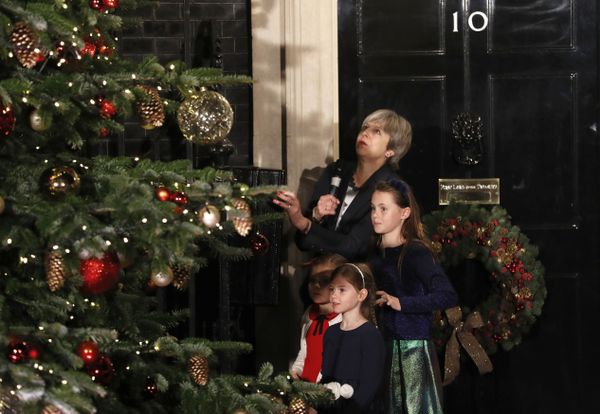 Britain's Prime Minister Theresa May stands with children as she switches on the Christmas tree lights at 10 Downing Street in London, Wednesday, Dec. 6, 2017.  - Sputnik International