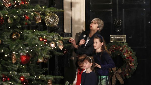 Britain's Prime Minister Theresa May stands with children as she switches on the Christmas tree lights at 10 Downing Street in London, Wednesday, Dec. 6, 2017. Britain's Prime Minister Theresa May stands with children as she switches on the Christmas tree lights at 10 Downing Street in London, Wednesday, Dec. 6, 2017. - Sputnik International