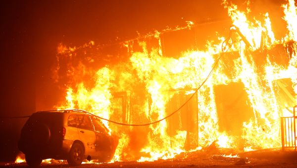 A structure is seen engulfed in flames during the Camp Fire in Paradise A structure is seen engulfed in flames during the Camp Fire in Paradise - Sputnik International