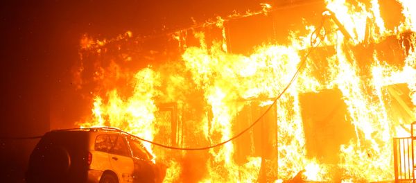 A structure is seen engulfed in flames during the Camp Fire in Paradise A structure is seen engulfed in flames during the Camp Fire in Paradise - Sputnik International