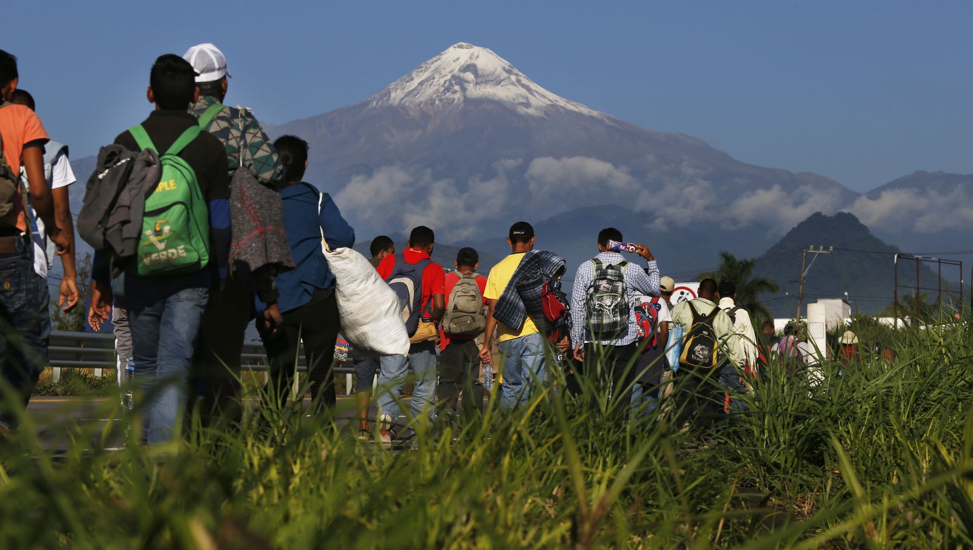 Central American migrants begin their morning trek as part of a thousands-strong caravan hoping to reach the U.S. border, as they face the Pico de Orizaba volcano upon departure from Cordoba, Veracruz state, Mexico, Monday, Nov. 5, 2018. A big group of Central Americans pushed on toward Mexico City from a coastal state Monday, planning to exit a part of the country that has long been treacherous for migrants seeking to get to the United States. Central American migrants begin their morning trek as part of a thousands-strong caravan hoping to reach the U.S. border, as they face the Pico de Orizaba volcano upon departure from Cordoba, Veracruz state, Mexico, Monday, Nov. 5, 2018. A big group of Central Americans pushed on toward Mexico City from a coastal state Monday, planning to exit a part of the country that has long been treacherous for migrants seeking to get to the United States. - Sputnik International, 1920, 24.02.2021