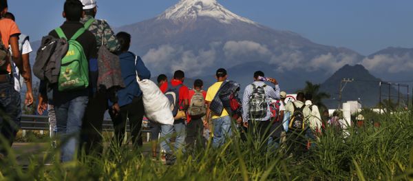 Central American migrants begin their morning trek as part of a thousands-strong caravan hoping to reach the U.S. border, as they face the Pico de Orizaba volcano upon departure from Cordoba, Veracruz state, Mexico, Monday, Nov. 5, 2018. A big group of Central Americans pushed on toward Mexico City from a coastal state Monday, planning to exit a part of the country that has long been treacherous for migrants seeking to get to the United States. - Sputnik International