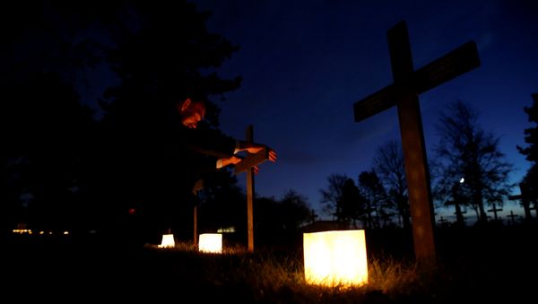 Paul Hoetten, from Bottrop in Germany prays after placing a candle at the grave of a German soldier at the German war cemetery, on the eve of celebrations for Armistice Day, 100 years after the end of the First World War, in Neuville-Saint-Vaast, France, November 10, 2018 - Sputnik International