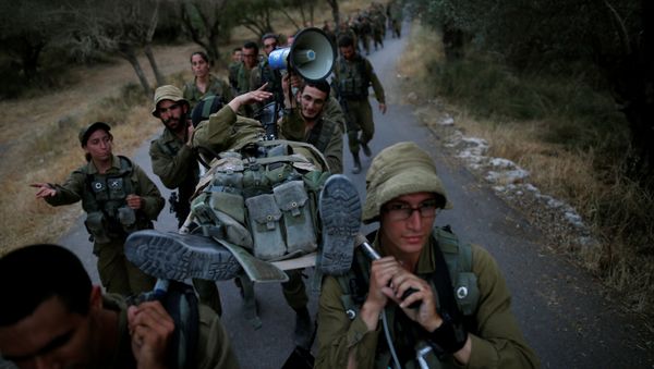 Israeli soldiers of the Search and Rescue brigade carry their comrade on a stretcher during a training session in Ben Shemen forest, near the city of Modi'in May 23, 2016 Israeli soldiers of the Search and Rescue brigade carry their comrade on a stretcher during a training session in Ben Shemen forest, near the city of Modi'in May 23, 2016 - Sputnik International