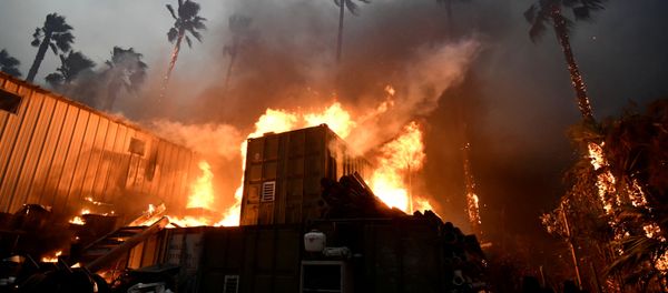 A home is engulfed in flames during the Woolsey Fire in Malibu, California - Sputnik International