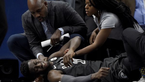 Brooklyn Nets guard Caris LeVert (22) is tended to after an injury during the second quarter of an NBA basketball game against the Minnesota Timberwolves on Monday, Nov. 12, 2018, in Minneapolis - Sputnik International