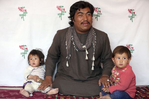In this Oct. 26, 2018 photo, Jawad Mohammadi, a former member of the Afghan National Security Forces, sits with his children as he gives an interview to The Associated Press, at his home in Kabul, Afghanistan.  - Sputnik International