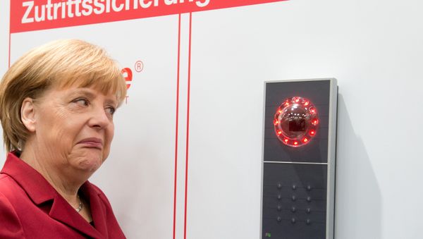 German Chancellor Angela Merkel grimaces as access is denied to her at the stand of security equipment maker tisoware during her opening tour of the CeBIT computer fair in Hannover, northern Germany, Tuesday, March 5, 2013. - Sputnik International
