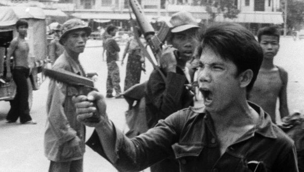 FILE - In this 17 April 1975 file photo, a Khmer Rouge soldier waves his pistol and orders store owners to abandon their shops in Phnom Penh, Cambodia as the capital fell to the communist forces - Sputnik International