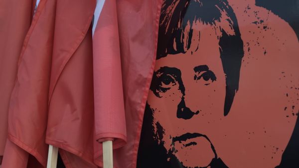 A poster showing German Chancellor Angela Merkel is displayed at a car during a protest against the visit of German Chancellor Angela Merkel at the East German city Chemnitz on Friday, Nov. 16, 2018. - Sputnik International