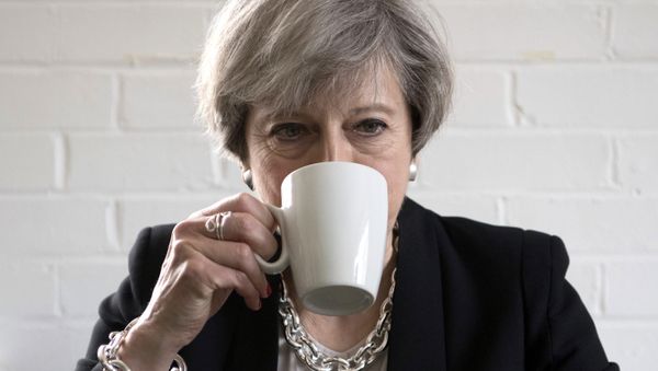 Britain's Prime Minister Theresa May drinks from a mug as she meets youth activists during a visit to the Young Minds mental health charity while on the election campaign trail, in London, Thursday May 11, 2017. Britain will hold a general election on June 8. Britain's Prime Minister Theresa May drinks from a mug as she meets youth activists during a visit to the Young Minds mental health charity while on the election campaign trail, in London, Thursday May 11, 2017. Britain will hold a general election on June 8. - Sputnik International