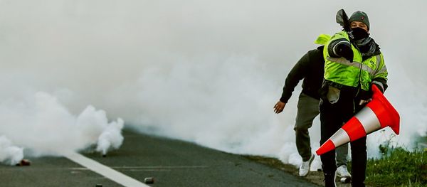 A man throws a projectile on Caen's circular road on November 18, 2018 in Caen, northwestern France, on a second day of action after a nationwide popular initiated day of protest called yellow vest (Gilets Jaunes in French) movement against high fuel prices which has mushroomed into a widespread protest against stagnant spending power under French President. A man throws a projectile on Caen's circular road on November 18, 2018 in Caen, northwestern France, on a second day of action after a nationwide popular initiated day of protest called yellow vest (Gilets Jaunes in French) movement against high fuel prices which has mushroomed into a widespread protest against stagnant spending power under French President. - Sputnik International
