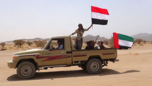Yemeni tribesmen from the Popular Resistance Committees, supporting forces loyal to Yemen's Saudi-backed fugitive President Abedrabbo Mansour Hadi, hold the Emirati (R) and Yemeni flag as they drive in Marib province, east of the Yemeni capital, Sanaa, on September 20, 2015 Yemeni tribesmen from the Popular Resistance Committees, supporting forces loyal to Yemen's Saudi-backed fugitive President Abedrabbo Mansour Hadi, hold the Emirati (R) and Yemeni flag as they drive in Marib province, east of the Yemeni capital, Sanaa, on September 20, 2015 - Sputnik International