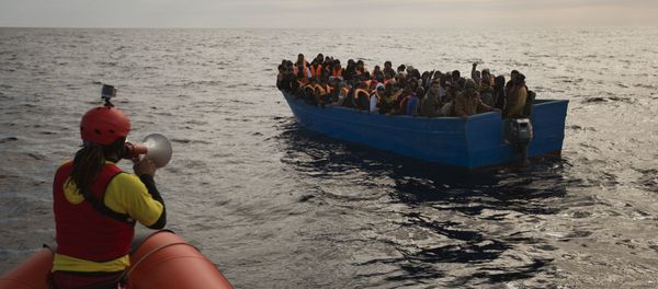Migrants and refugees are assisted by members of the Spanish NGO Proactiva Open Arms, as they crowd aboard a boat sailing out of control in the Mediterranean Sea about 21 miles north of Sabratha, Libya, on Friday, Feb. 3, 2017. European Union leaders are poised to take a big step on Friday in closing off the illegal migration routes from Libya across the central Mediterranean, where thousands have died trying to reach the EU, the EU foreign affairs chief Federica Mogherini said. - Sputnik International