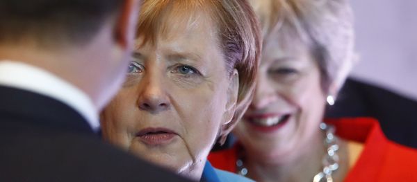 German Chancellor Angela Merkel, left, and British Prime Minister Theresa May wait for the beginning of the plenary session of the informal EU summit in Salzburg, Austria, Thursday, Sept. 20, 2018. - Sputnik International