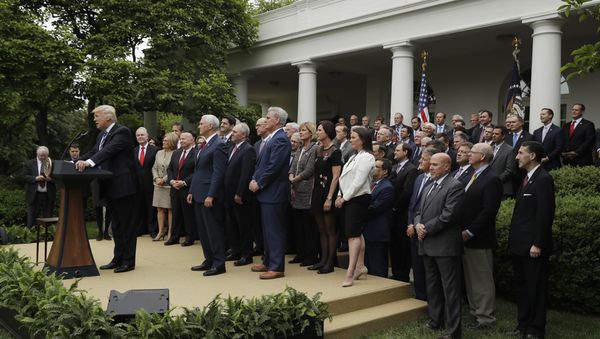 President Donald Trump, accompanied by House GOP members, speaks in the Rose Garden of the White House in Washington, Thursday, May 4, 2017, after the House pushed through a health care bill - Sputnik International