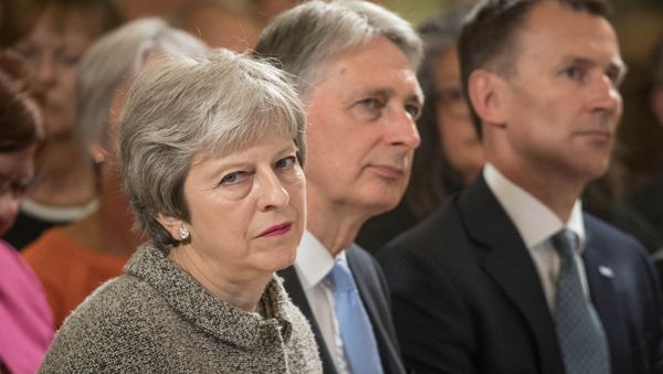 Britain's Prime Minister Theresa May sits next to Chancellor of the Ecxhequer Philip Hammond, and Health Secretary Jeremy Hunt during an event at the Royal Free Hospital, London June 18, 2018 Britain's Prime Minister Theresa May sits next to Chancellor of the Ecxhequer Philip Hammond, and Health Secretary Jeremy Hunt during an event at the Royal Free Hospital, London June 18, 2018 - Sputnik International