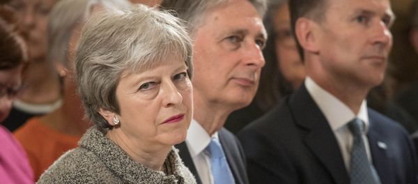 Britain's Prime Minister Theresa May sits next to Chancellor of the Ecxhequer Philip Hammond, and Health Secretary Jeremy Hunt during an event at the Royal Free Hospital, London June 18, 2018 Britain's Prime Minister Theresa May sits next to Chancellor of the Ecxhequer Philip Hammond, and Health Secretary Jeremy Hunt during an event at the Royal Free Hospital, London June 18, 2018 - Sputnik International