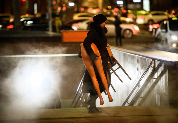 A woman carries half a mannequin as she exits an underpass in central Moscow A woman carries half a mannequin as she exits an underpass in central Moscow - Sputnik International