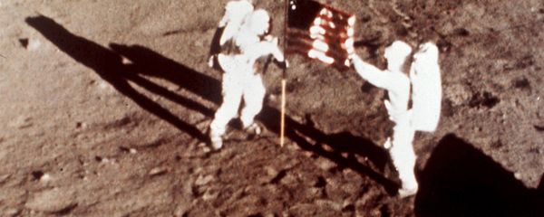 Apollo 11 astronauts Neil Armstrong and Edwin E. Buzz Aldrin, the first men to land on the moon, plant the U.S. flag on the lunar surface, July 20, 1969. Photo was made by a 16mm movie camera inside the lunar module, shooting at one frame per second Apollo 11 astronauts Neil Armstrong and Edwin E. Buzz Aldrin, the first men to land on the moon, plant the U.S. flag on the lunar surface, July 20, 1969. Photo was made by a 16mm movie camera inside the lunar module, shooting at one frame per second - Sputnik International