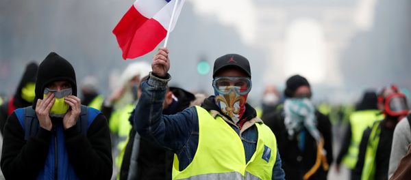 Masked protesters wearing yellow vests, a symbol of a French drivers' protest against higher fuel prices, take part in a demonstration on the Champs-Elysees in Paris, France, November 24, 2018 Masked protesters wearing yellow vests, a symbol of a French drivers' protest against higher fuel prices, take part in a demonstration on the Champs-Elysees in Paris, France, November 24, 2018 - Sputnik International