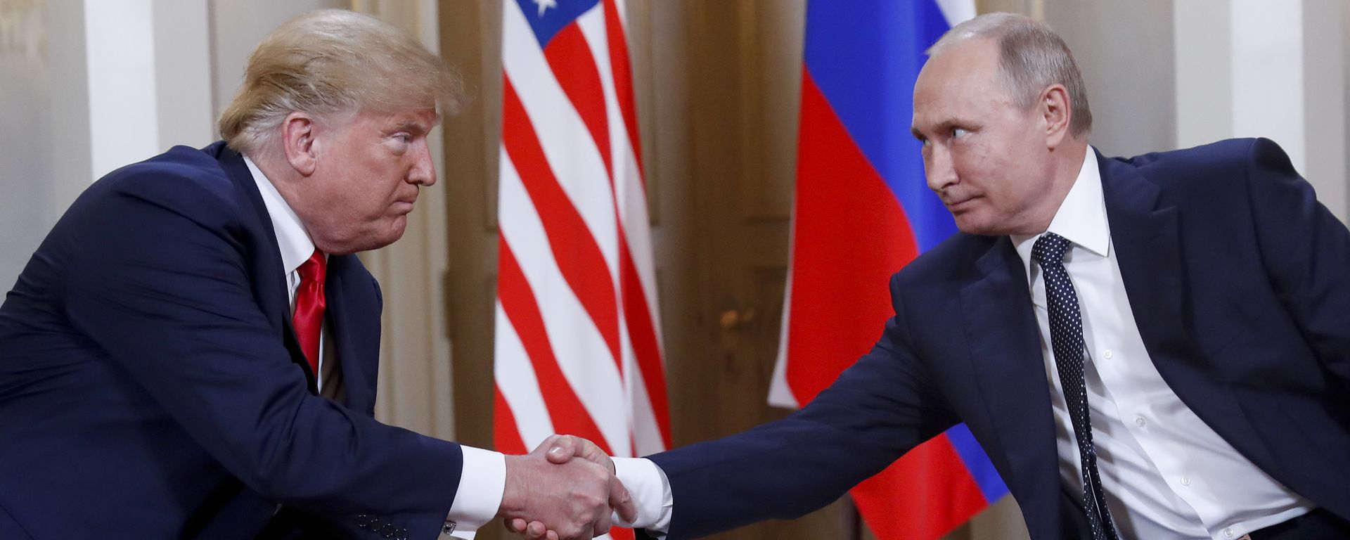 In this file photo taken on Monday, July 16, 2018, U.S. President Donald Trump, left, and Russian President Vladimir Putin, shake hands at the beginning of a meeting at the Presidential Palace in Helsinki, Finland. - Sputnik International, 1920, 19.05.2025