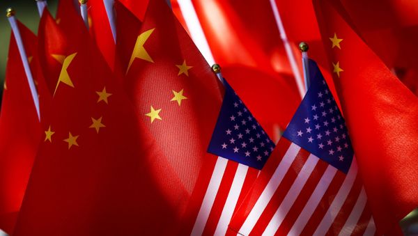 In this Sept. 16, 2018, file photo, American flags are displayed together with Chinese flags on top of a trishaw in Beijing - Sputnik International