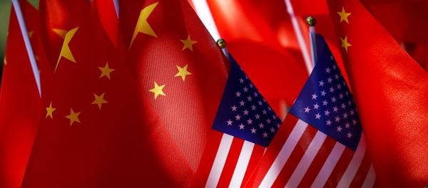 In this Sept. 16, 2018, file photo, American flags are displayed together with Chinese flags on top of a trishaw in Beijing - Sputnik International